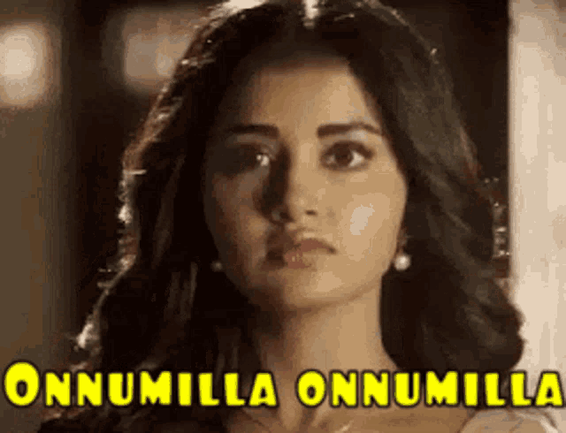 a close up of a woman 's face with the words onnumilla onnumilla written above her