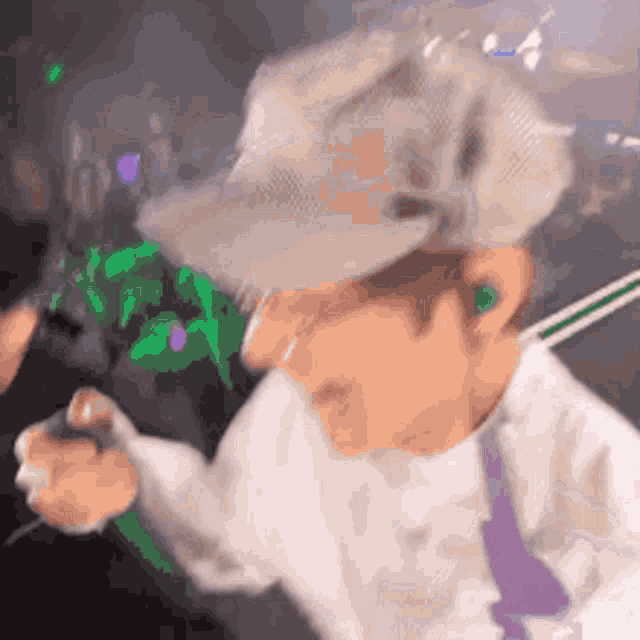 a blurry picture of a person wearing a hat and earbuds .