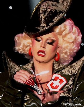 a picture of a drag queen with a cross on her chest