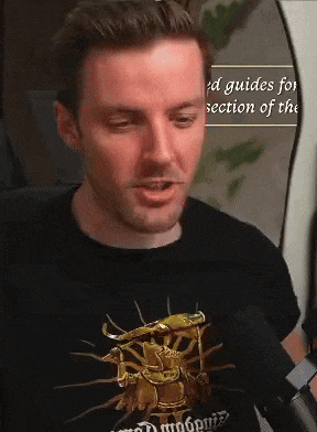 a man wearing a black shirt that says guides for section of the on it