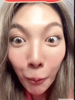 a close up of a woman making a funny face with her eyes closed