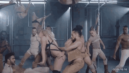 a group of men and women are dancing in a room with the time displayed as 00:01:16