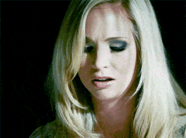 a close up of a woman 's face with a black background