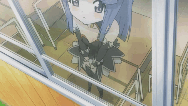 a girl in a black dress stands in a classroom looking out a window