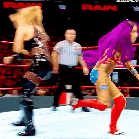 a female wrestler with purple hair is running in a ring