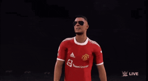 a man wearing sunglasses and a red adidas jersey