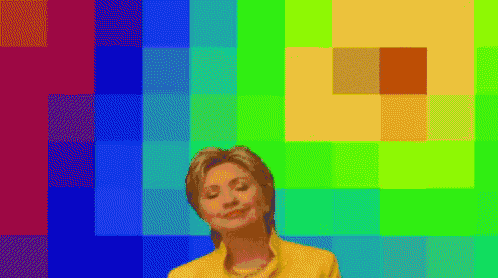 a woman in a yellow shirt is standing in front of a rainbow background .