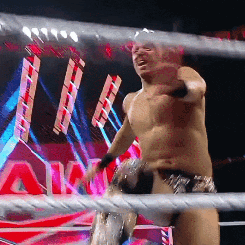 a shirtless wrestler in a wrestling ring with the word a on the back