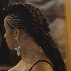 a woman with a braided hairstyle and earrings says forever