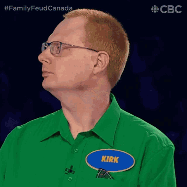a man wearing glasses and a green shirt is named kirk
