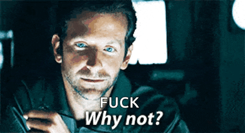 a man with blue eyes is holding a cell phone and says " fuck why not "