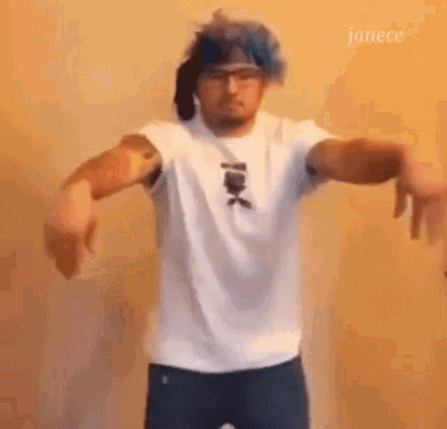 a man wearing a white shirt and blue hair is dancing .
