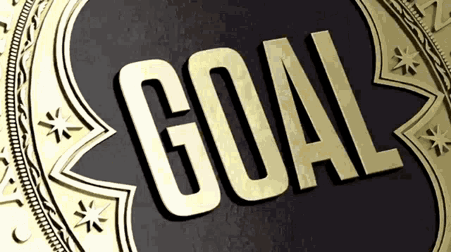 a gold medal with the word goal written inside of it