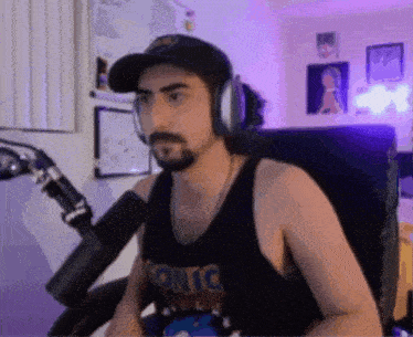 a man wearing headphones and a tank top that says " sonic "