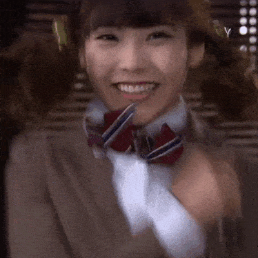 a close up of a woman wearing a suit and tie .