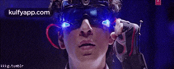 a man wearing sunglasses and gloves with blue lights on his eyes