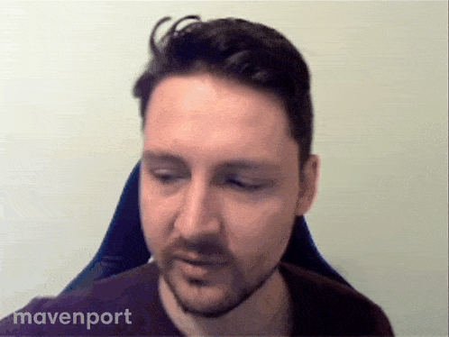 a man with a beard is sitting in a chair with mavenport written on the bottom right
