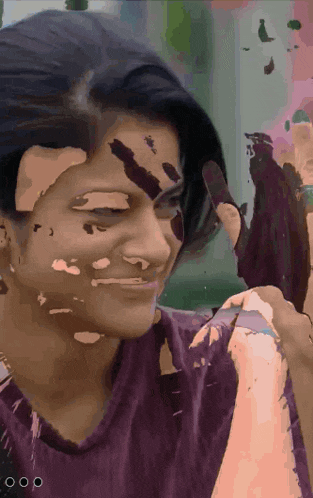 a woman with paint on her face is smiling