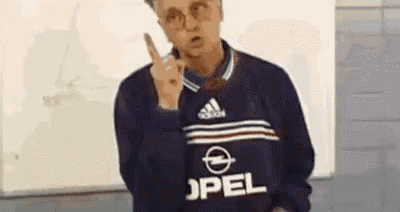 a man wearing a blue opel sweater is giving the middle finger .