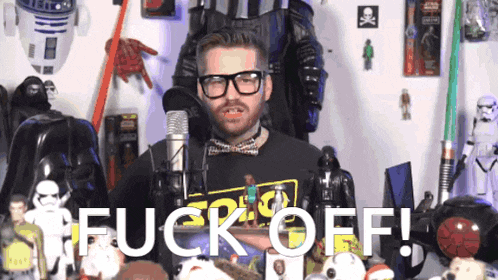 a man wearing glasses and a black shirt that says " fuck off "