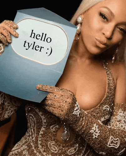 a woman holding a card that says hello tyler on it