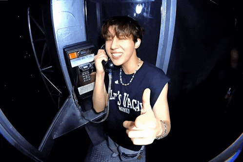 a man giving a thumbs up while wearing a shirt that says " let 's vaca "