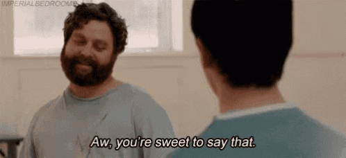a man with a beard is talking to another man and saying `` aw , you 're sweet to say that . ''