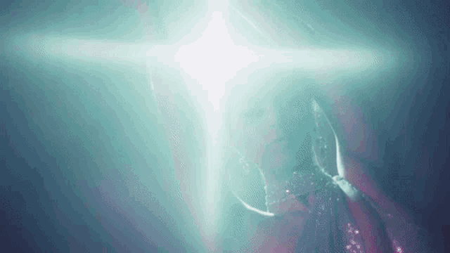 a close up of a person 's face with a light shining on it .