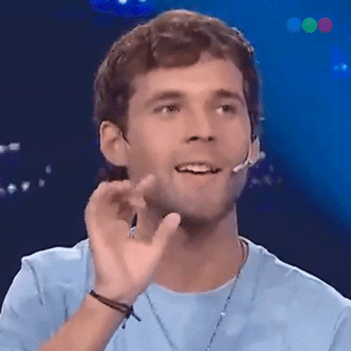 a man wearing a blue shirt and a microphone on his ear