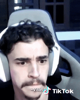 a man wearing headphones and a mustache has a tiktok sticker on his face