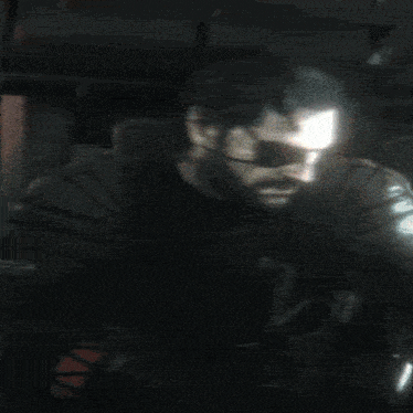 a man wearing a gas mask is behind a sign that says " gluch7 "