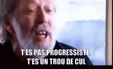a man with a beard is saying " t'es pas progressiste "