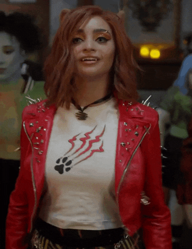 a woman wearing a red jacket and a white t-shirt with a paw print on it