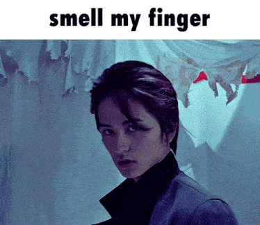a picture of a man with the words " smell my finger " above him