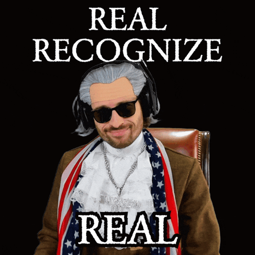 a man wearing a wig and sunglasses with the words " real recognize real " behind him