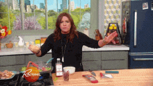 a woman is standing in a kitchen with a bottle that says ' r ' on it