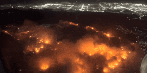 an aerial view of a fire at night