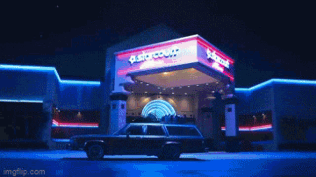 a car is parked in front of a building that says quatro court
