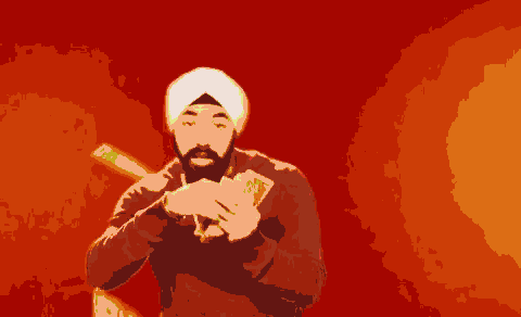 a man wearing a turban is holding a piece of paper in his hands .