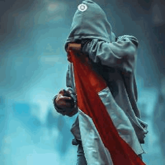 a person wearing a hoodie is holding a red and white flag .