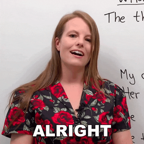 a woman in a red and black floral shirt says " alright "