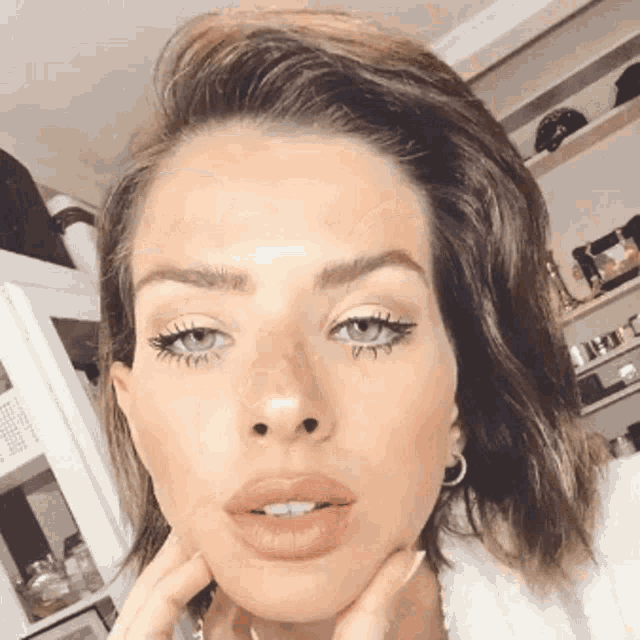 a close up of a woman 's face with makeup on