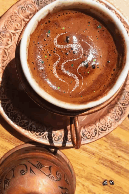 a cup of coffee with a snake drawn in it