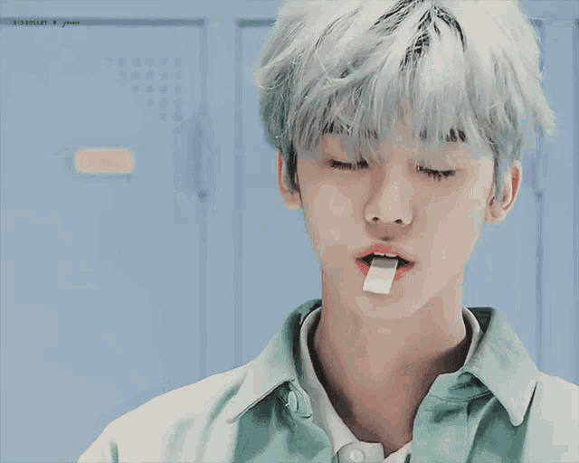 a close up of a person 's face with a piece of gum in their mouth
