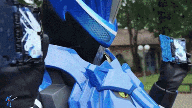 a person in a blue robot costume is holding a blue item