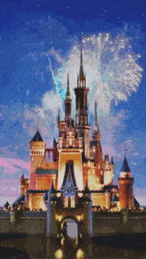 a disney castle with fireworks behind it