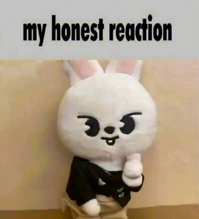 a stuffed animal is giving a thumbs up and the words `` my honest reaction '' are above it .