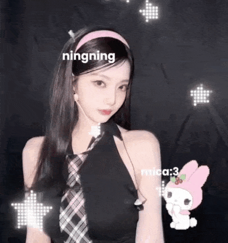 a girl wearing a headband and a tie is standing in front of a black background with a pink bunny .