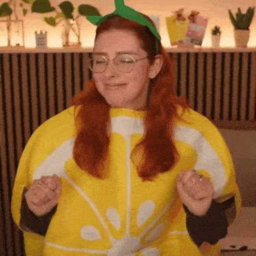 a woman with red hair is wearing a lemon costume and glasses