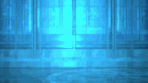 a blue light is shining through a window in a dark room